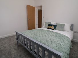A bedroom with a bed and pillows at 5 Marsh Lane in Flint