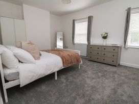 A bedroom with a bed and dresser at 5 Marsh Lane in Flint
