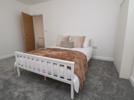 A bedroom with a bed and a door at 5 Marsh Lane Flint