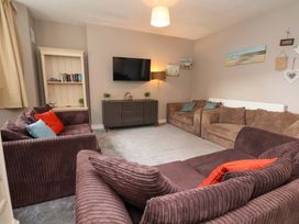 A living room with a television and sofa arrangements at The Corner House in Scarborough