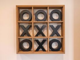 A framed tic-tac-toe game on the wall at The Corner House in Scarborough
