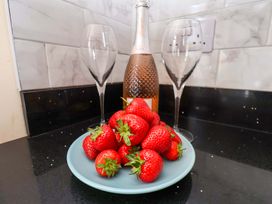 A plate of strawberries with a champagne bottle and wine glasses at The Corner House in Scarborough