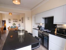 A kitchen with a countertop, stove, and dining area at The Corner House Scarborough