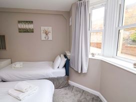 A bedroom with two beds and a window at The Corner House in Scarborough