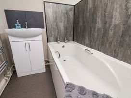 A bathroom with a bathtub and a sink at The Corner House in Scarborough