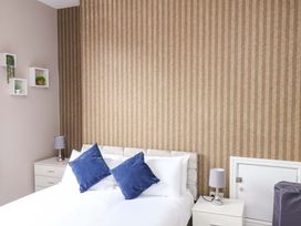 A bedroom with a bed and nightstands at The Corner House in Scarborough