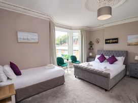 A bedroom with two beds and natural light at The Corner House in Scarborough