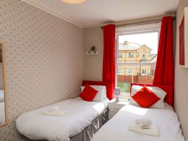 A bedroom with two beds and a window at The Corner House in Scarborough