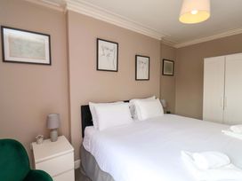 A bedroom with a bed and bedside table at The Corner House in Scarborough