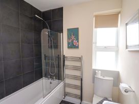 A bathroom featuring a bathtub, toilet, and shower at The Corner House in Scarborough