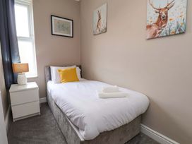 A bedroom with a single bed and a lamp at The Corner House in Scarborough