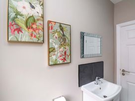 A bathroom with a sink and wall art at The Corner House in Scarborough
