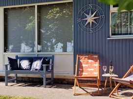 An outdoor seating area with a sofa and chairs at Driftwood in Dartmouth