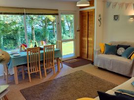 A living room with a dining table and chairs at Driftwood in Dartmouth