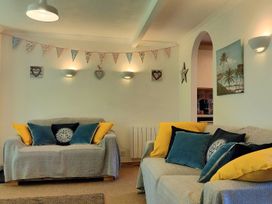 A living room with sofas and wall decorations at Driftwood in Dartmouth
