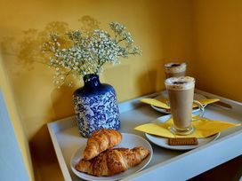 A tray with coffee, croissants, flowers, and a cookie at Driftwood in Dartmouth