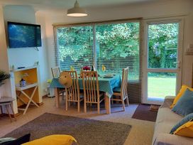A dining room with a table and chairs at Driftwood in Dartmouth