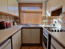 A kitchen with appliances and window light at Driftwood in Dartmouth