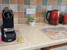 A kitchen with a coffee maker and kettle at Driftwood in Dartmouth