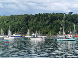 Boats docked in a marina with trees in the background at Driftwood in Dartmouth