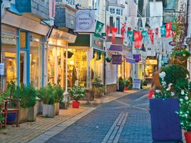 A street with shops and decorative flags at Driftwood in Dartmouth