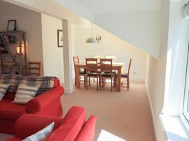A living room with a dining area and bookshelf at Waterfall in Ambleside