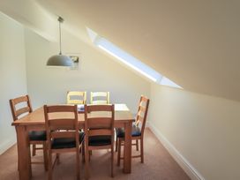 A dining room with a table and chairs at Waterfall in Ambleside