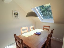A dining room with a wooden table and chairs at Waterfall in Ambleside