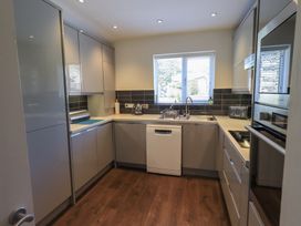 A kitchen with cabinets and a sink at Waterfall in Ambleside