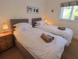 A bedroom with two single beds and a bedside lamp at Waterfall in Ambleside
