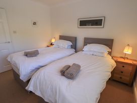 A bedroom with twin beds and a nightstand at Waterfall in Ambleside