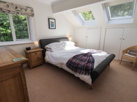 A bedroom with a bed and window at Waterfall in Ambleside