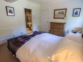 A bedroom with a bed and a dresser at Waterfall in Ambleside