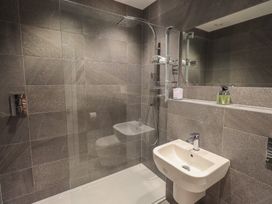 A bathroom with a shower and sink at Waterfall in Ambleside