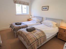 A bedroom with twin beds and bedside table at Waterfall in Ambleside