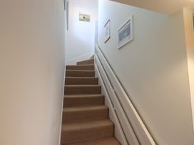 A staircase with carpet and wall frames at Waterfall in Ambleside