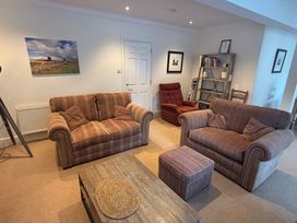 A living room with a sofa and chair at Waterfall in Ambleside