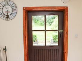 An entryway with a door and clock at Orchard Barn Wexford