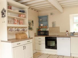 A kitchen with shelves and appliances at Orchard Barn in Wexford