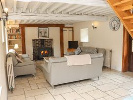 A living room with sofas and a fireplace at Orchard Barn in Wexford