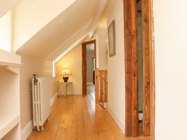 A hallway with a lamp and radiator at Orchard Barn in Wexford