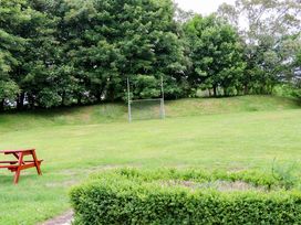 An outdoor area with goal posts and a bench at Orchard Barn in Wexford