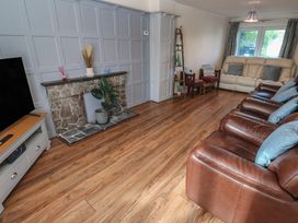 A living room with a television, sofa and fireplace at 28 Guildford Road