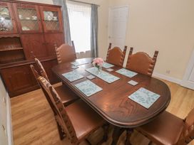 A dining room with a wooden table and chairs at 28 Guildford Road
