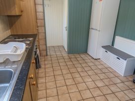 A kitchen with a sink, stove, and refrigerator at 28 Guildford Road