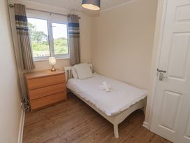 A bedroom with a bed and chest of drawers at 28 Guildford Road