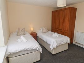 A bedroom with twin beds and a wardrobe at 28 Guildford Road 