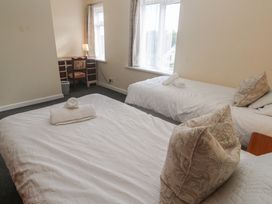 A bedroom with two beds and a desk at 28 Guildford Road