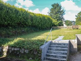 A garden with stairs leading up to a grass area at 28 Guildford Road