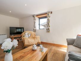 A living room with a television and sofa at The Bull Pen in Yeovil, Somerset